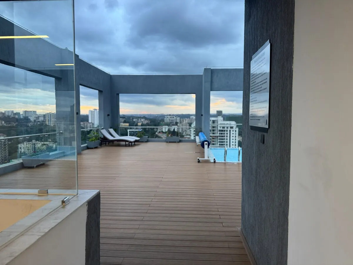 Rooftop pool deck with loungers and a view over the city