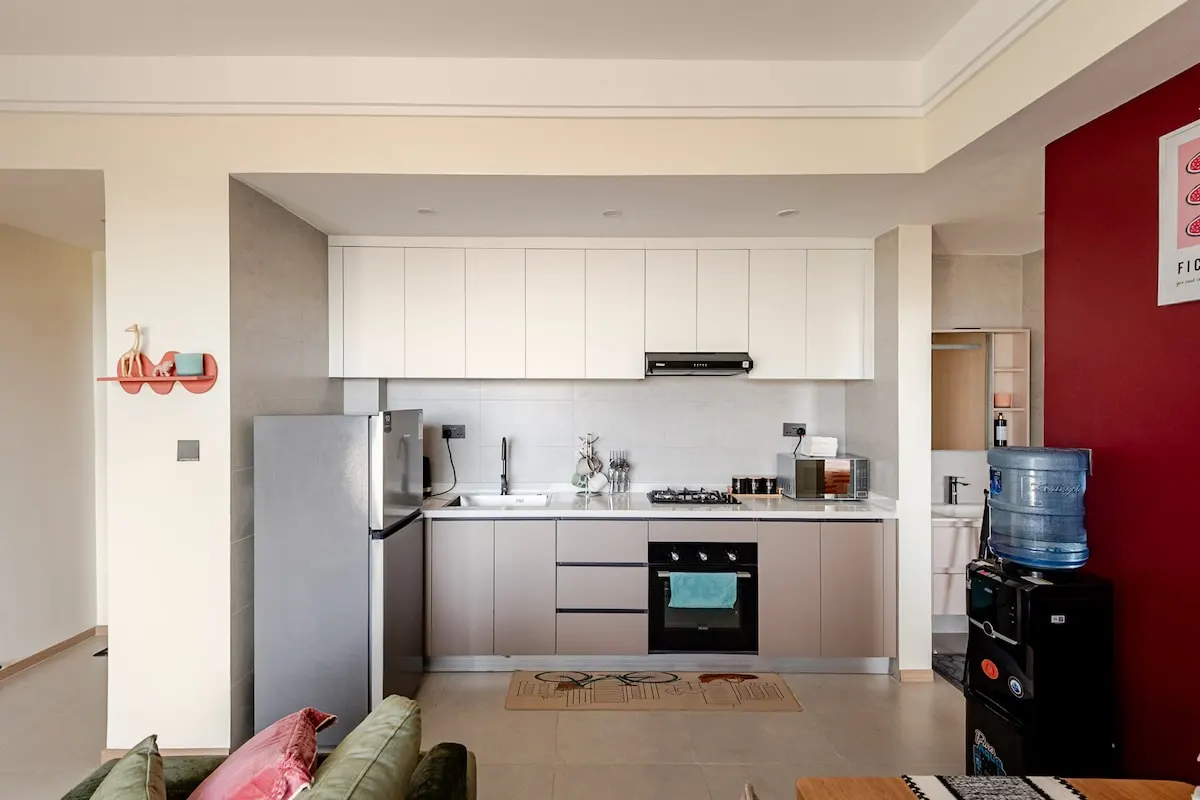 Kitchen with fridge, gas hob, oven and water dispenser