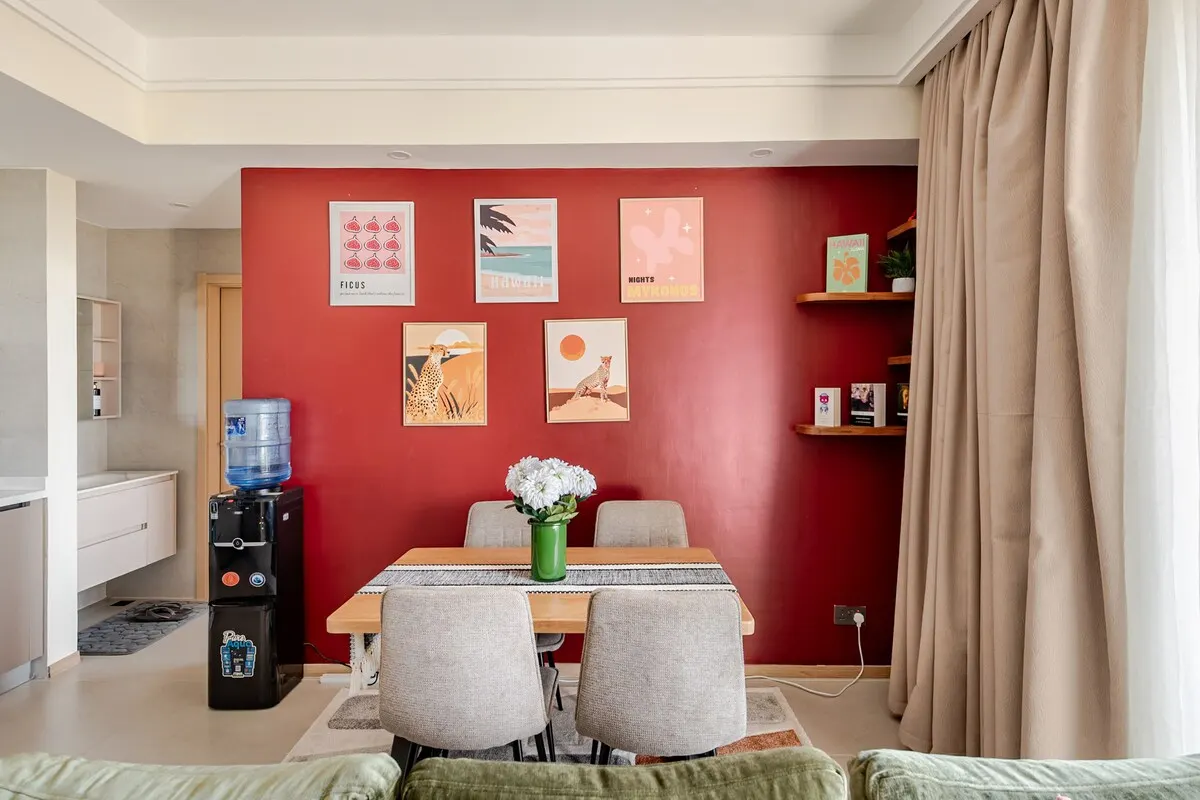 Dining table for four against the red wall