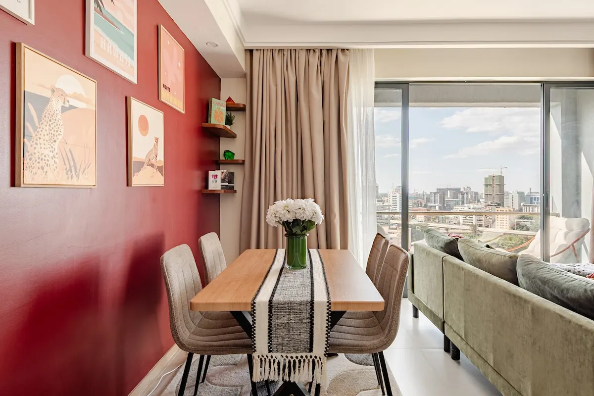Dining table by the window, with the city behind