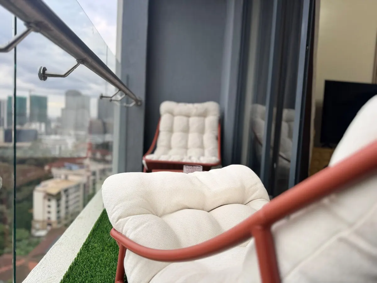 Balcony armchair with the city skyline below